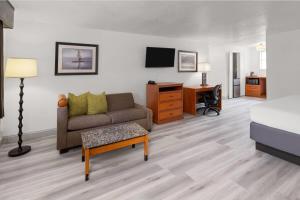 a living room with a couch and a desk at Baymont by Wyndham Durango in Durango
