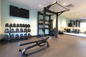 a room with a gym with a bench and a tv at Tru By Hilton Hazleton in Hazleton