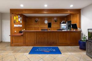 a large lobby with a large wooden reception desk at Baymont by Wyndham Texas City in Texas City +22 photos
