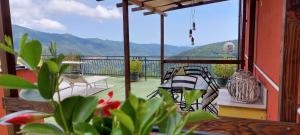 a balcony with chairs and a view of the mountains at Agriturismo Dinoabbo Ulivi in Lucinasco