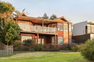 a large house with a balcony and a yard at Seaview Escape in Ventnor