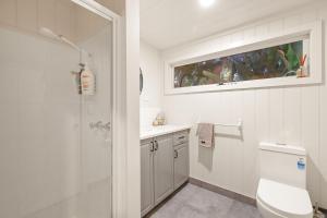 a bathroom with a toilet and a sink and a window at Seaview Escape in Ventnor +21 photos