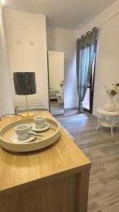 a table with two cups and a plate on it at La Cupoletta -Holiday House - GILDA in Trevignano Romano
