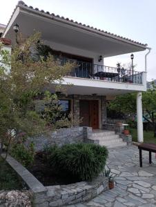 a house with a balcony on top of it at Palio Dream House in Paleo Tsifliki