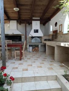 a large outdoor kitchen with a pizza oven at Palio Dream House in Paleo Tsifliki