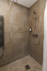 a bathroom with a shower with a glass door at Jūratės B&B Namai in Karmėlava +20 photos