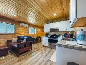 a kitchen and living room with a couch in a room at Cozy Pine Getaway in Sequim