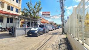 a street with cars parked on the side of the road at My place 77 2 in Ban Khlong Khwang Klang