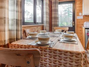 a table with bowls and plates on it in a kitchen at Burnside Park in Keswick