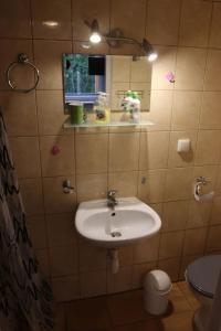a bathroom with a sink and a mirror at Minuta do plaży - Sarbinowo in Sarbinowo +54 photos