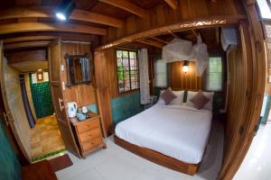 a small bedroom with a bed in a round room at Blue Sky Monjam in Chiang Mai