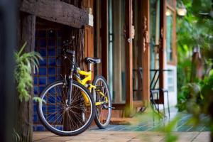 a yellow bike parked on the side of a building at Blue Sky Monjam in Chiang Mai