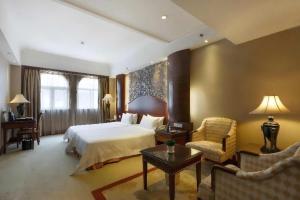 a bedroom with a bed and a couch and a table at Grand Palace Hotel - Grand Hotel Management Group in Guangzhou +39 photos