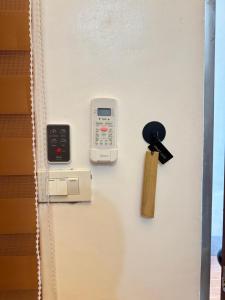 a door with a key and a remote control on it at Spacious Bunk Bed & Dedicated Workspace in Baler