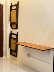a wooden shelf on the wall in a room at Spacious Bunk Bed & Dedicated Workspace in Baler +1 photo