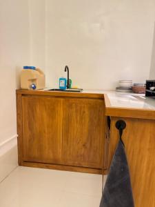 a kitchen with a sink and a wooden counter top at Spacious Bunk Bed & Dedicated Workspace in Baler
