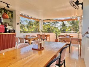 a dining room with a large wooden table and chairs at Taylors Plantacion Resort- Grande Ground Floor in Tangaro