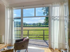 a room with a window with a view of a field at Yew Tree Barn - Hw7737 in Usk