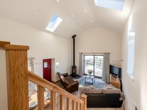 a living room with a couch and a tv at Parlwr Godro - Uk41513 in Llanfair Clydogau