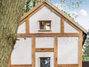a play house built around a tree at Jacobs Folly-Qu7115 in Melton Constable