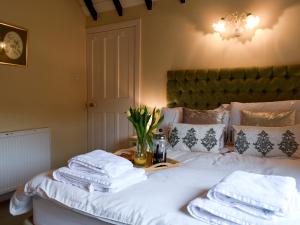 a bedroom with a bed with white towels on it at Puzzle Corner in Sandsend