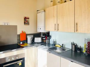 a kitchen with a sink and a counter top at The Wee Cottage - Uk42919 in Dunfermline