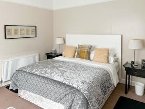 a bedroom with a large bed and two night stands at The Wee Cottage - Uk42919 in Dunfermline +12 photos