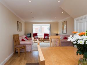 a living room with two couches and a table at Oakridge in Salcombe