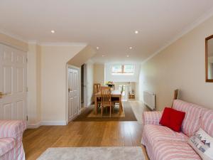 a living room with a couch and a table at Oakridge in Salcombe