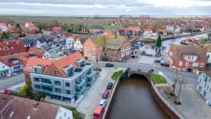 an aerial view of a city with a bridge at Nr 301 - Apartmenthaus "Harleblick" in Carolinensiel