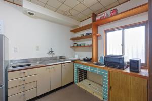 a kitchen with a sink and a microwave at Authentic Local Experience House in Nara