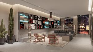 a living room with a couch and a table and chairs at SHANKEE Hotel Melawai Blok M Jakarta in Jakarta