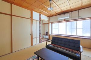 a living room with a couch and a table at Authentic Local Experience House in Nara