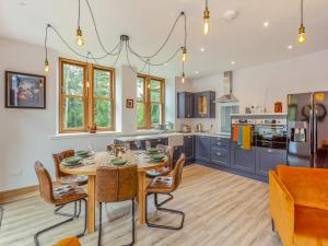 a kitchen with a table and chairs in a room at Gardeners Cottage in Huntly