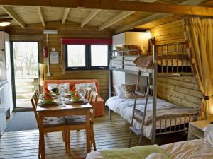 a room with bunk beds and a table in a cabin at Kestrel Cabin - Uk1246 in Westward