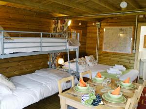a room with two bunk beds and a table with plates of food at Kestrel Cabin - Uk1246 in Westward