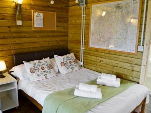 a bed with two pillows on it in a room at Kestrel Cabin - Uk1246 in Westward +2 photos