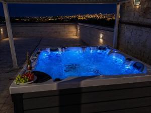 a jacuzzi tub on a balcony at night at Tenuta Ulivi in Putignano