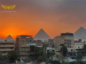 a view of the pyramids of giza at sunset at Zak Pyramids Inn in Cairo