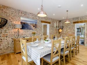 a dining room with a table and chairs at Pipistrelle Barn in North Walsham