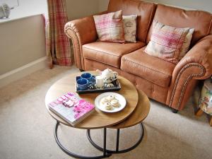 a living room with a coffee table and a couch at Summergate Cottage in Annan