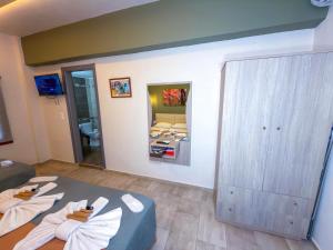 a bedroom with a bed and a large mirror at Elafonisi Paradise with Parking, WiFi, - Walking Distance to the Beach in Elafonisi