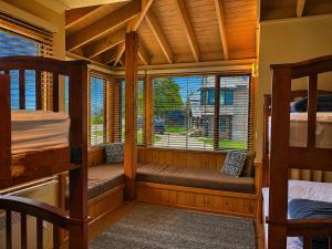a room with two bunk beds and a window at Dragonfly Chalet in Dinner Plain