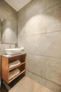 a bathroom with a sink and a mirror at Hotel Tranquil Airport Road Sector 66 Mohali Chandigarh in Mohali +63 photos