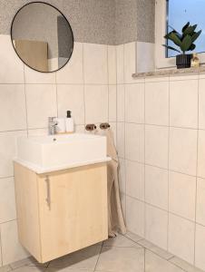 a bathroom with a sink and a mirror at Blaues Häuschen an der Burg in Neuenstein +11 photos