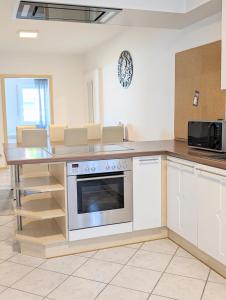 a kitchen with a stove and a counter top at Blaues Häuschen an der Burg in Neuenstein