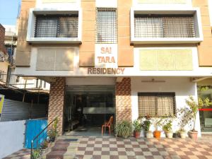 a building with a sign that reads san tara residency at Sai Tara Residency in Shirdi