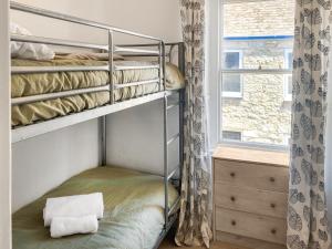 a bunk bed in a room with a window at Nautilus in St Ives +9 photos