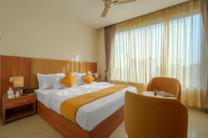 a hotel room with a large bed and a window at Hotel Tranquil Airport Road Sector 66 Mohali Chandigarh in Mohali