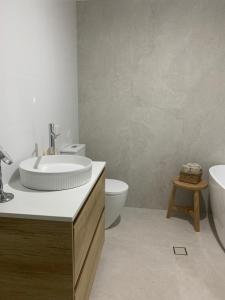 a bathroom with a sink and a toilet at Se-Ayr BnB at Lighthouse in Port Macquarie